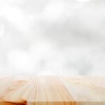 Wood table top on white bokeh abstract background.